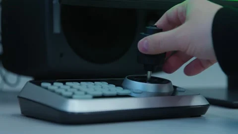 An engineer is controlling with a black knob on a digital device Video stock 276662565