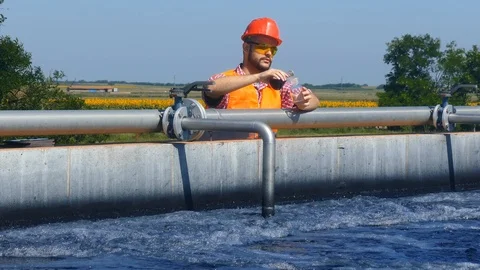 An engineer controlling a quality of water Stock Footage 125080659