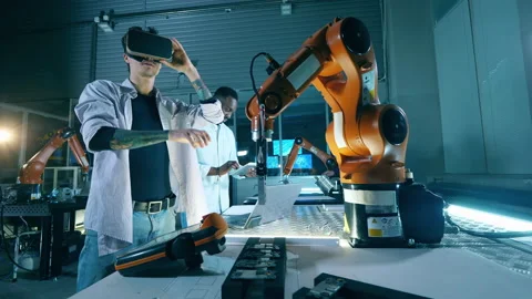 Engineer controlling robot using virtual reality glasses. Innovation, technology Stock Footage 145598455