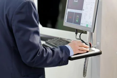 Engineer controls the equipment using a computer Stock Photos