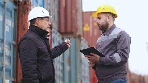 Engineer controls the loading of a container onto a cargo ship. Import and Video stock 141029269