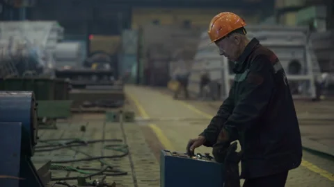 An engineer controls the machine producing complex turbine parts at a facility Stock Footage 203716396