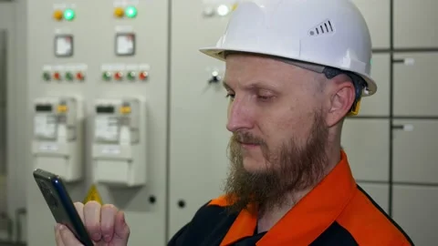 Engineer controls production equipment using smart phone in equipment control Stock Footage 172162318