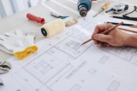 Engineer correcting building blueprint Stock Photos