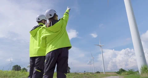 Engineer couple in bright jacket helmet observing turbine direction discussing Stock Footage 337163025