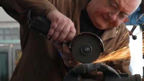 Engineer cutting metal using angle grinder while working in industrial worksh Stock-Footage 105839625