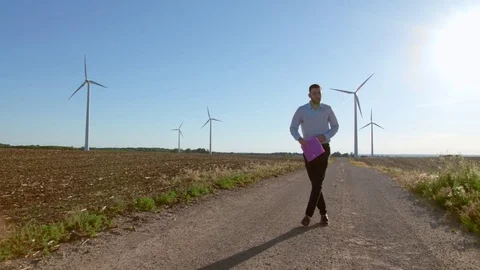Engineer dances on windmills background. Stock-Footage 76639687
