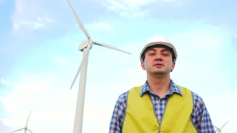 Engineer dancing in front of wind turbines ecological energy industry power Stock Footage 137971088