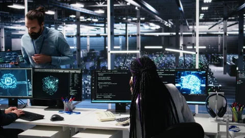 Engineer in data center answers telephone call, assisting users with AI Stock Footage 313567600