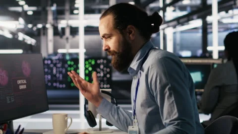 Engineer in data center frustrated by critical error popup on monitor Stock Footage 309777534
