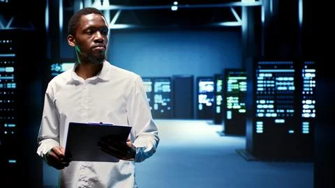 Engineer in data center housing servers Stock Photos