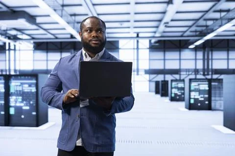Engineer in data center implementing and managing data backup solutions Stock Photos