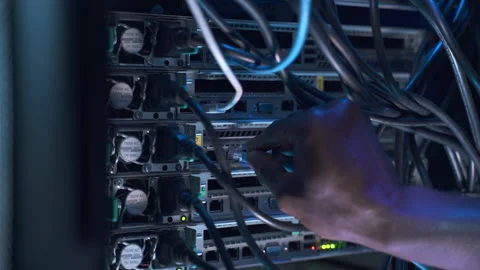 Engineer data center IT specialist switches cable to server Stock Footage 163814205