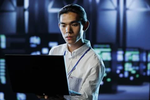 Engineer in data center with laptop Stock Photos