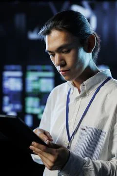 Engineer in data center with tablet Stock Photos