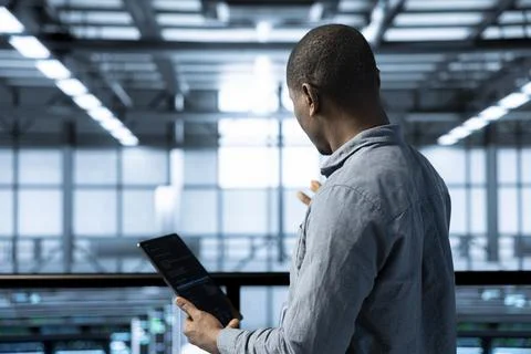 Engineer in data center using laptop adjusting power management settings 스톡 사진