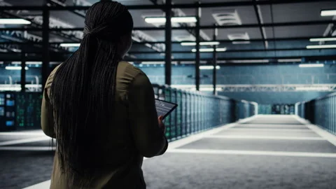 Engineer in data center using tablet to deploy secure server architecture Stock Footage 317123966