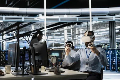 Engineer in data center using VR headset tech to verify parameters Stock Photos
