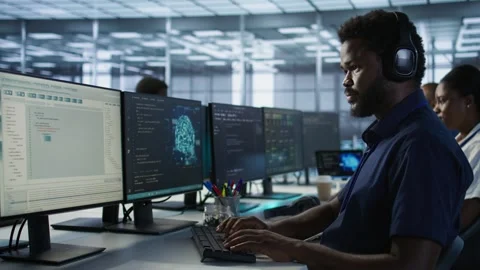 Engineer in data center wearing headphones, implementing AI systems Stock Footage 319550652