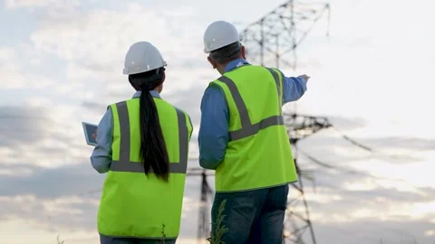 Engineer demonstrates electric power distribution substation to colleague Stock Footage 265308858