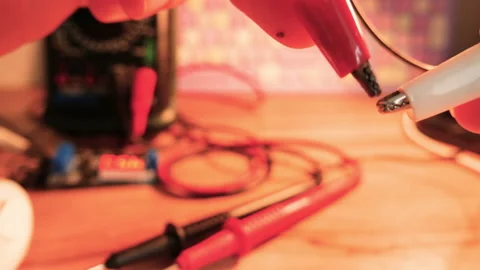 The engineer demonstrates the potential difference. Two crocodile connectors Stock Footage 184742680