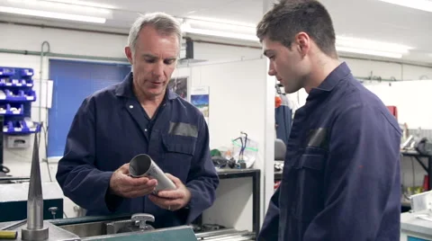 Engineer Demonstrating Machinery To Apprentice Video stock 40430307