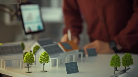 Engineer designing mini 3D models of solar panels to promote sustainable ene Stock Footage 323765345