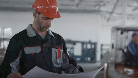 Engineer Designing Work of Machinery Manufacture. Male Person in Protective Hard Stock Footage 199475940