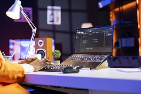 Engineer at desk typing code on notebook device, close up Stockfoto's