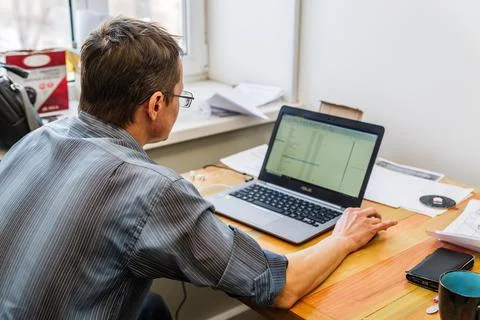 Engineer at the desktop with a laptop Stock Photos