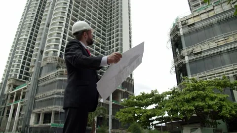 Engineer, developer at a construction site checks on the drawings at what stage Video stock 167368580
