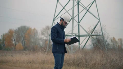 Engineer Developer With Hardhat Inspecting Building.Builder Constructor Stock Footage 164276648