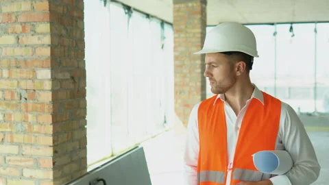 Engineer developer in helmet inspecting building. Architect are walking along Stock Footage 201291047