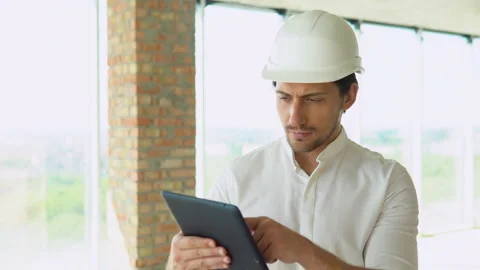 Engineer developer in helmet inspecting building. Builder constructor specialist Stock Footage 201293133