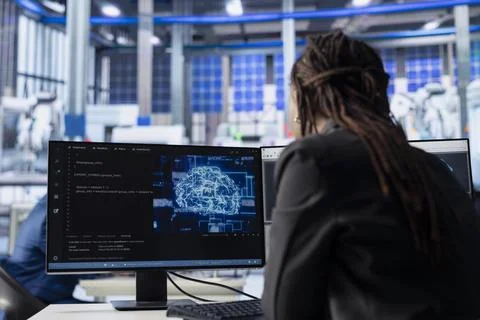 Engineer developing AI algorithms on PC in solar panel plant, training models Stock Photos