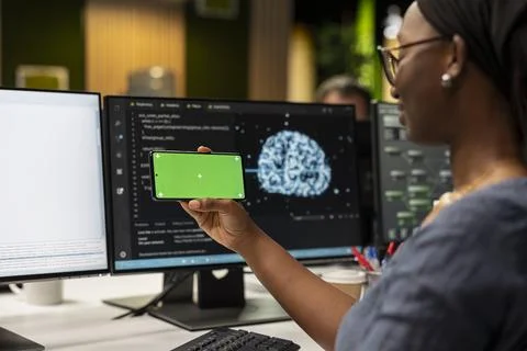 Engineer developing apps using AI automation on isolated screen smartphone 写真素材