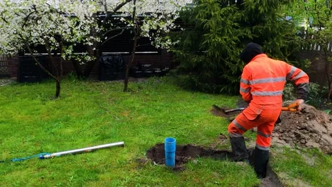 An engineer is digging the ground in a garden Video stock 194588196