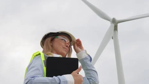 An engineer with a digital tablet checks the technical documentation for wind Stock Footage 272631392