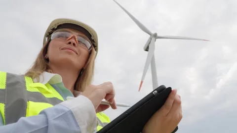 An engineer with a digital tablet implements new technologies in wind farms Stock-Footage 270990538