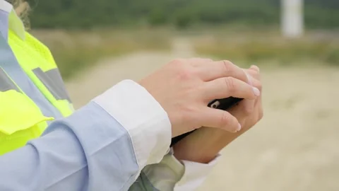 An engineer with a digital tablet studies the principle of operation of a wind Stock Footage 275186799