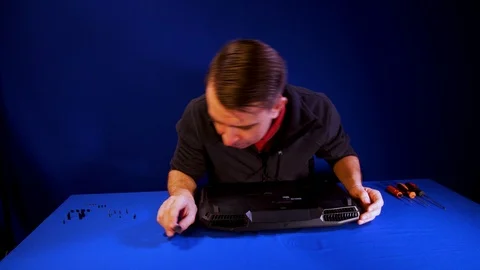 The engineer Disassembles the Laptop for Repair. Laptop motherboard. Time laps. Stock Footage 90735172