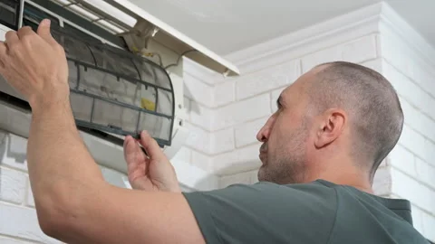 Engineer disassembling air conditioner. Stock Footage 284381112