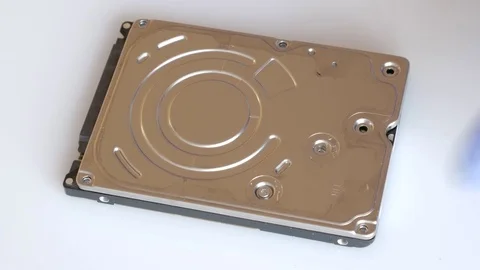 Engineer is disassembling broken hard disk drive for data recovery Stock Footage 72931711