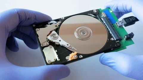 Engineer is disassembling broken hard disk drive for data recovery Stock Footage 72932199