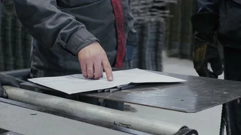 The engineer discusses the work plan with the workers. Working hands point a Stock Footage 163572452