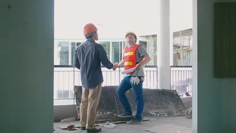 Engineer discussing with foreman about project in building construction site. Stock Footage 208939083