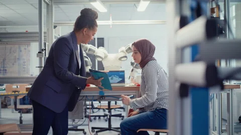 Engineer Discussing Robotic Arm With Arabic Computer Scientist Video stock 187561224