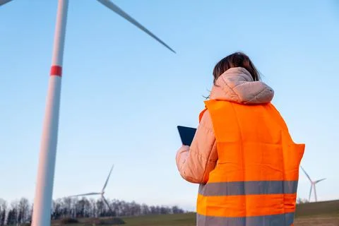 Engineer does maintenance and repairs wind wills or wind turbine using a tablet Stock Photos