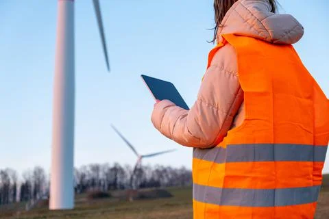 Engineer does maintenance and repairs wind wills or wind turbine using a tablet Stock Photos