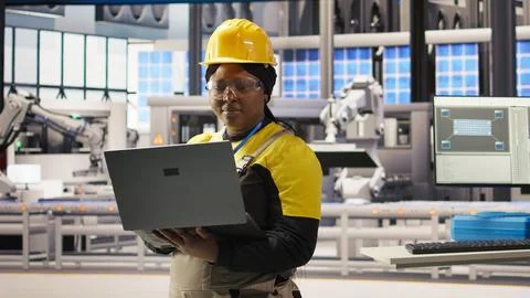 Engineer does predictive maintenance using laptop, analyzing IoT sensor data Stock Photos